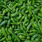 green chili peppers on green leaves